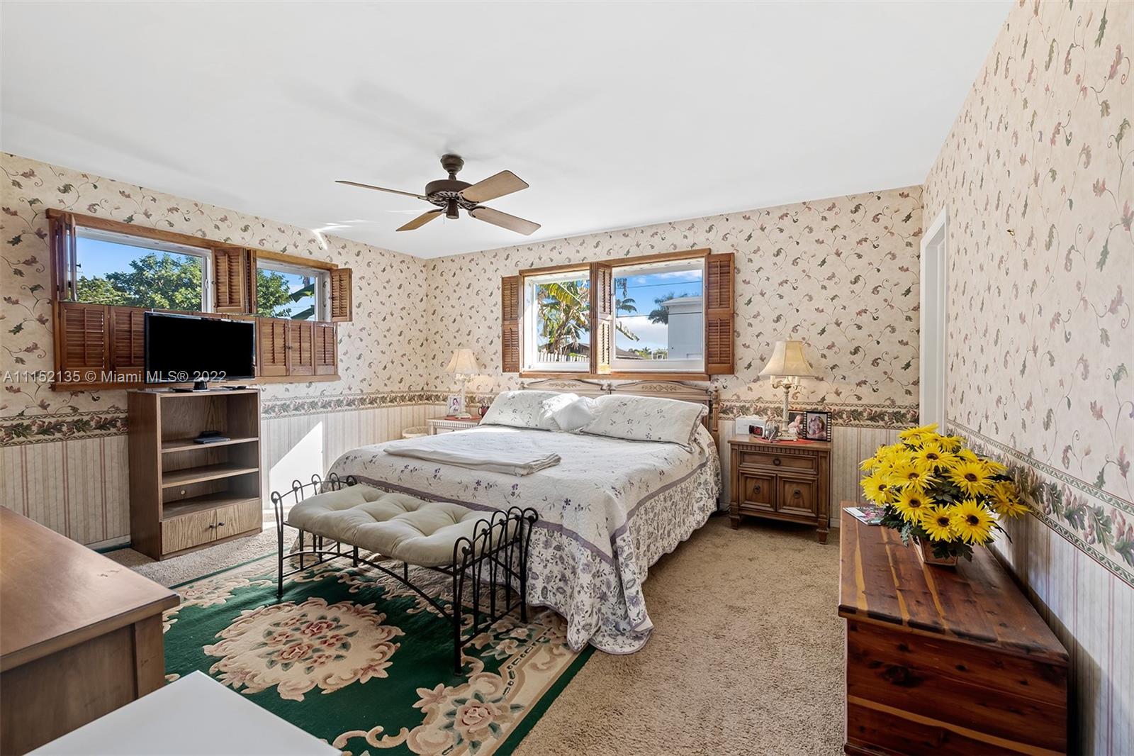 4314 Fillmore Street Hollywood, FL 33021 - Photo 16 of 27 a spacious bedroom with a bed and a flat screen tv