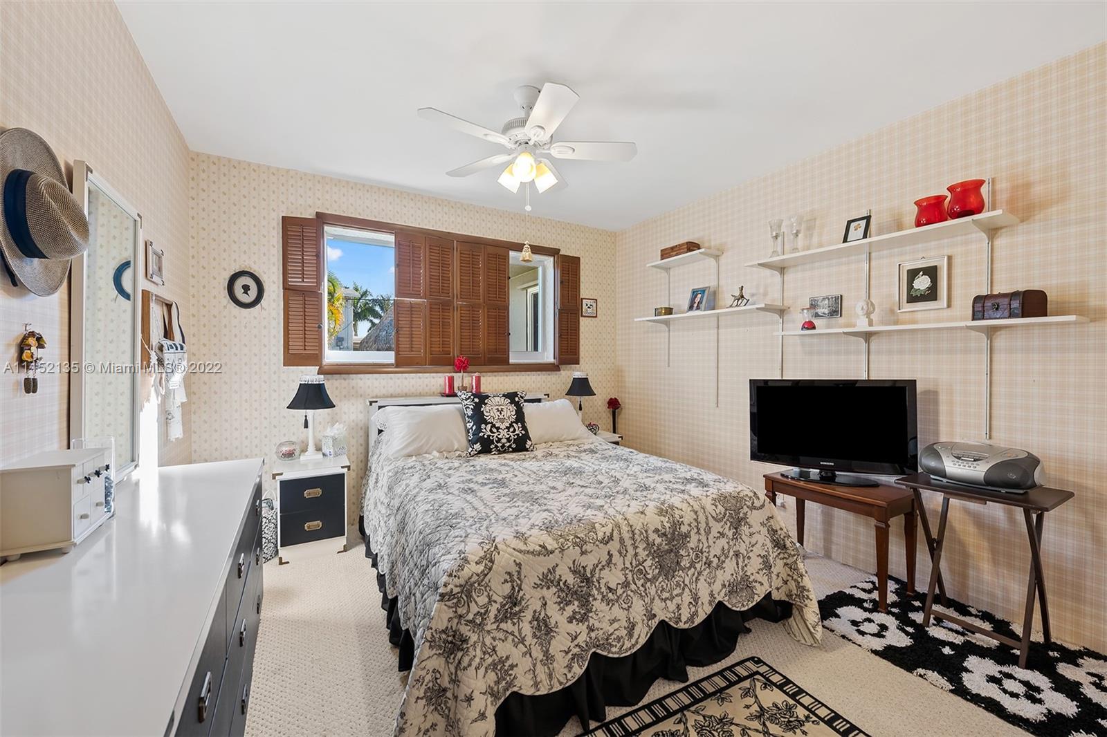 4314 Fillmore Street Hollywood, FL 33021 - Photo 19 of 27 a bedroom with a bed and a flat screen tv