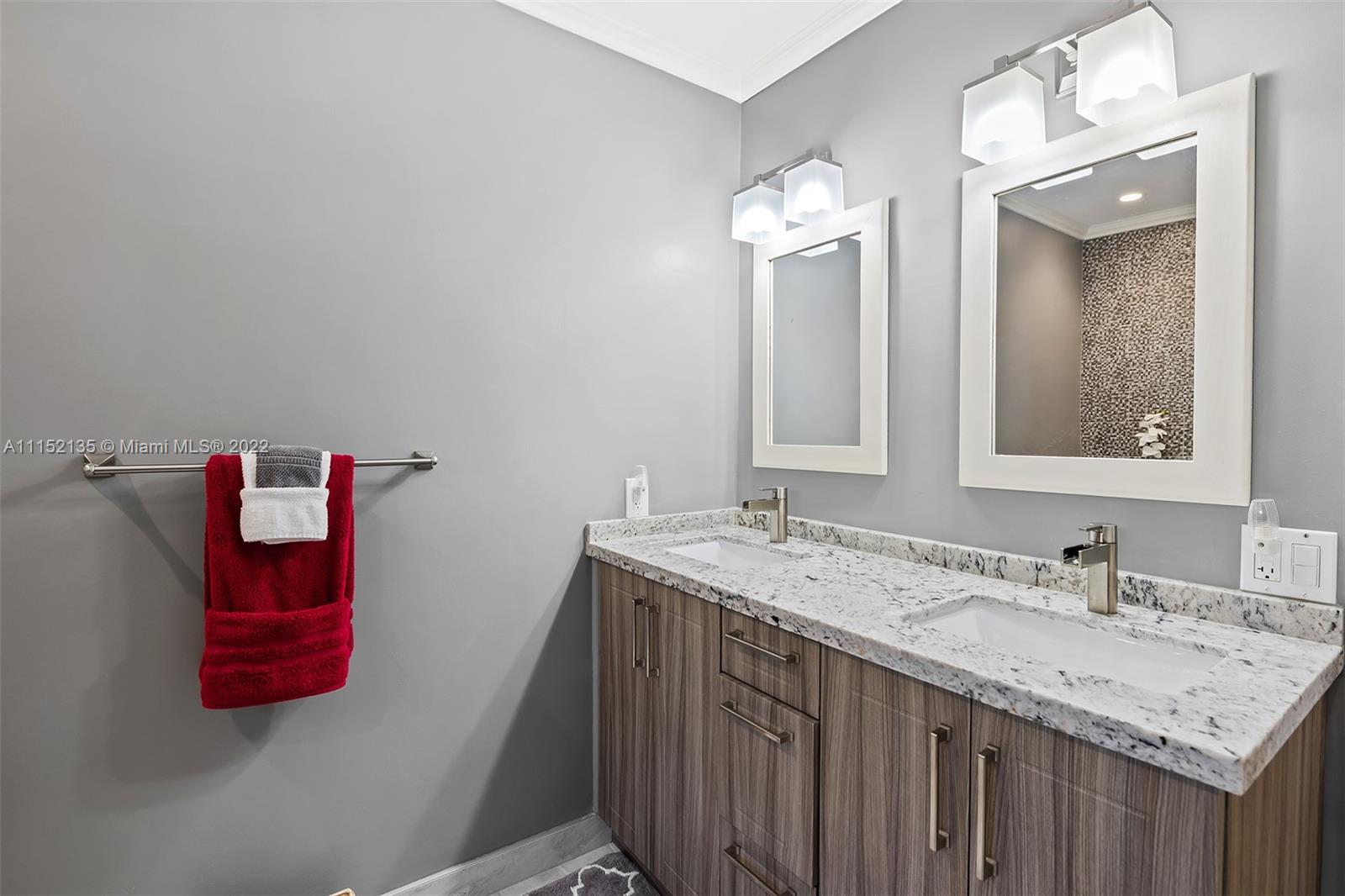 4314 Fillmore Street Hollywood, FL 33021 - Photo 22 of 27 a bathroom with a granite countertop sink and a mirror