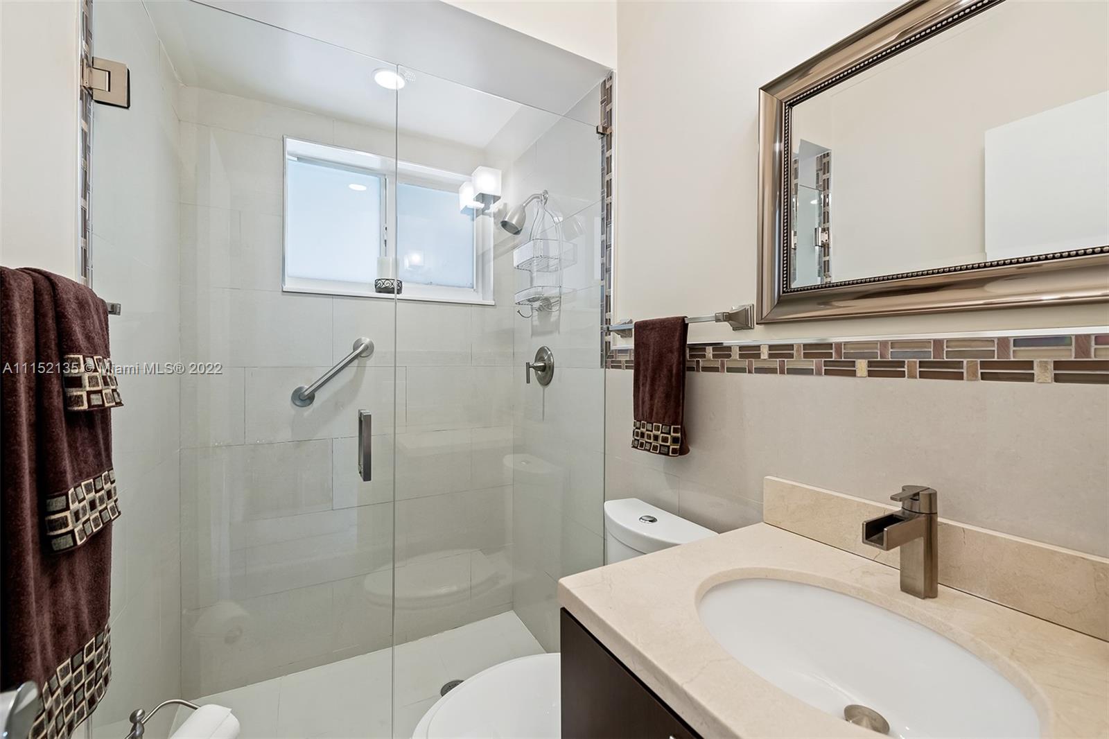 4314 Fillmore Street Hollywood, FL 33021 - Photo 24 of 27 a bathroom with a sink a toilet and shower