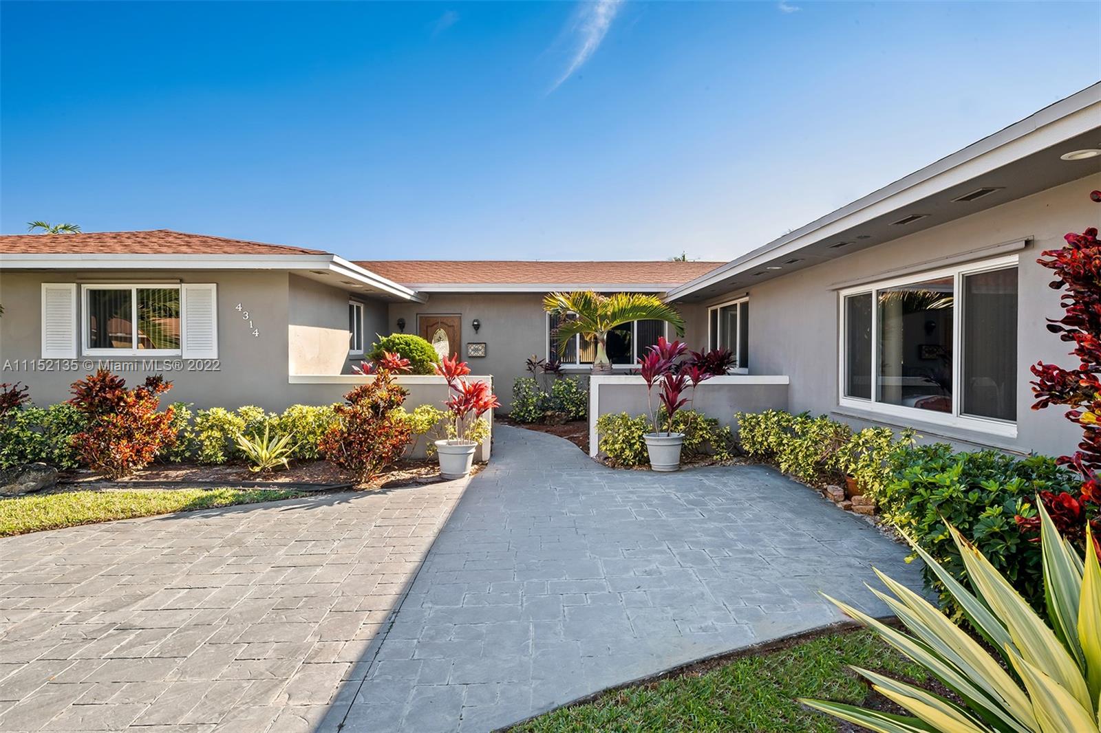 4314 Fillmore Street Hollywood, FL 33021 - Photo 3 of 27 a front view of a house with a yard