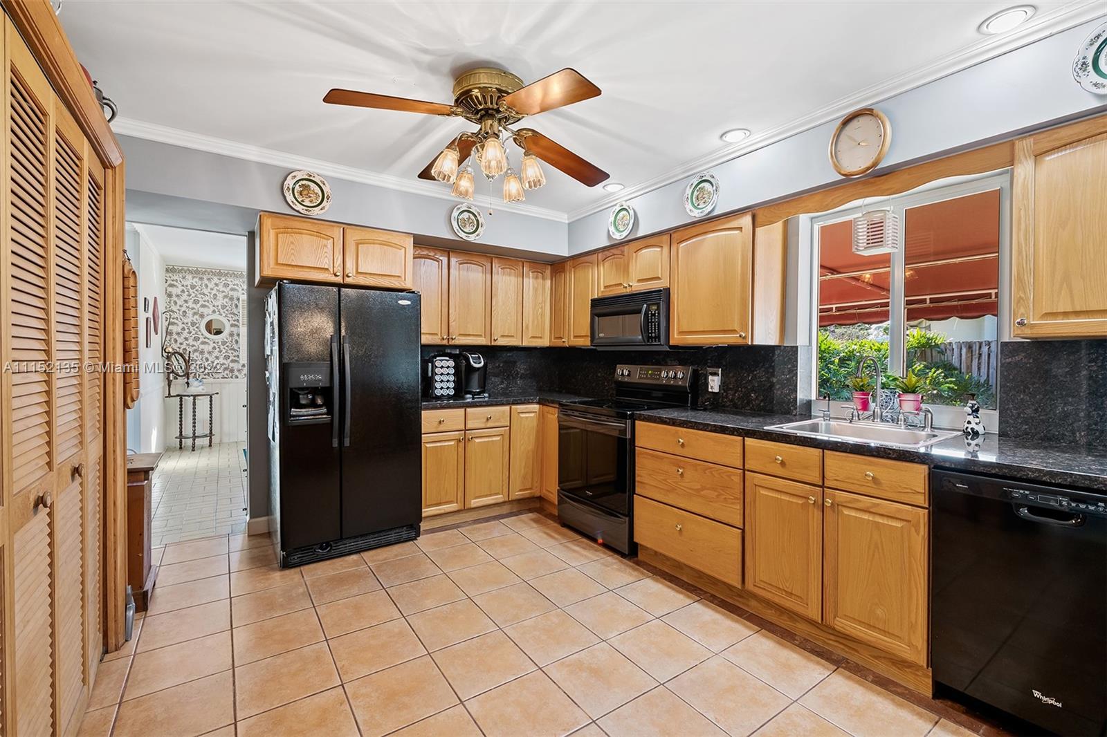 4314 Fillmore Street Hollywood, FL 33021 - Photo 7 of 27 a kitchen with stainless steel appliances granite countertop a refrigerator and a sink