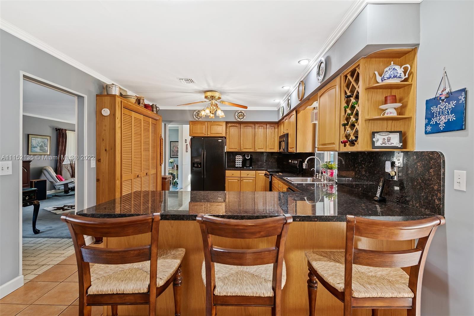 4314 Fillmore Street Hollywood, FL 33021 - Photo 9 of 27 a kitchen with stainless steel appliances kitchen island granite countertop a table and chairs