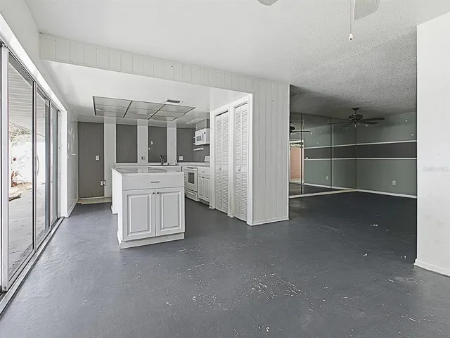 an empty room with a sink and mirror