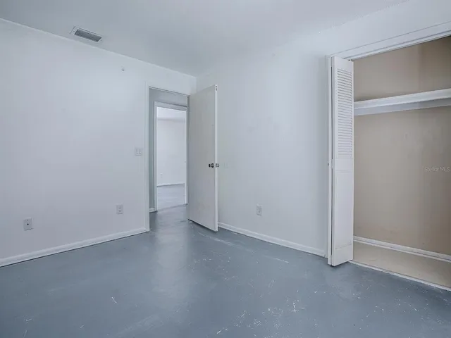 an empty room with closet area