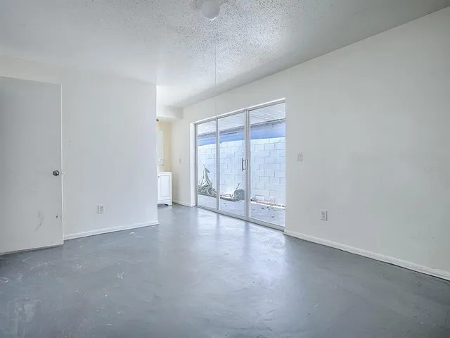a view of an empty room with a window
