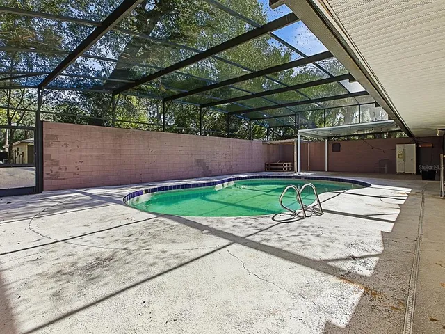 a view of a backyard with plants and a patio