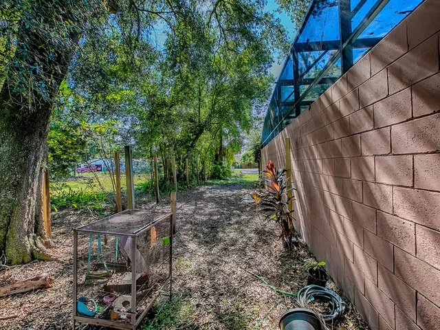 an aerial view of a house with large trees and plants