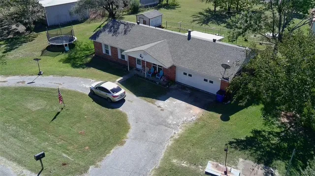 an aerial view of a house with a yard