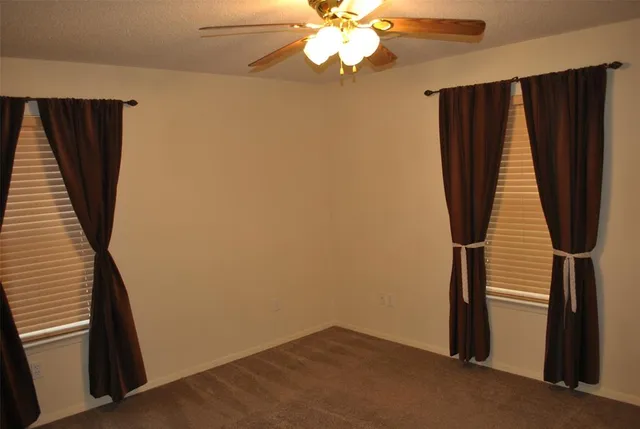 wooden floor in an empty room with a staircase