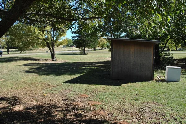a view of backyard space and trees