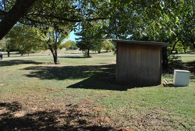 a view of backyard space and trees