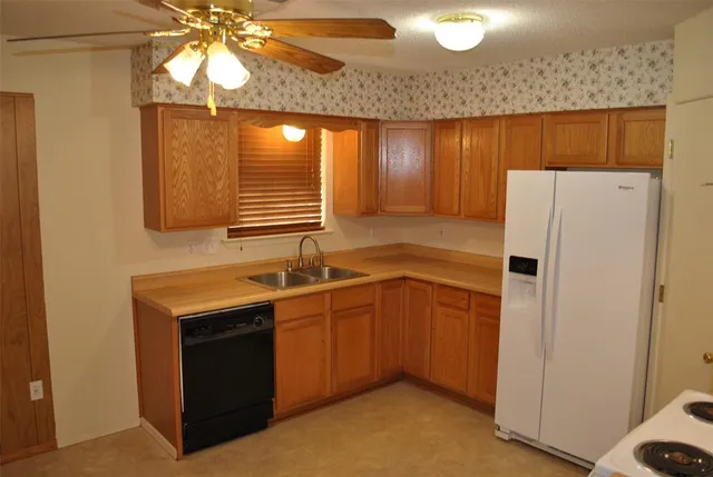 a kitchen with stainless steel appliances a refrigerator and a sink
