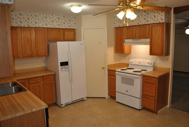 a kitchen with stainless steel appliances a stove a refrigerator and cabinets