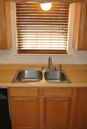 a kitchen with a sink a stove and cabinets