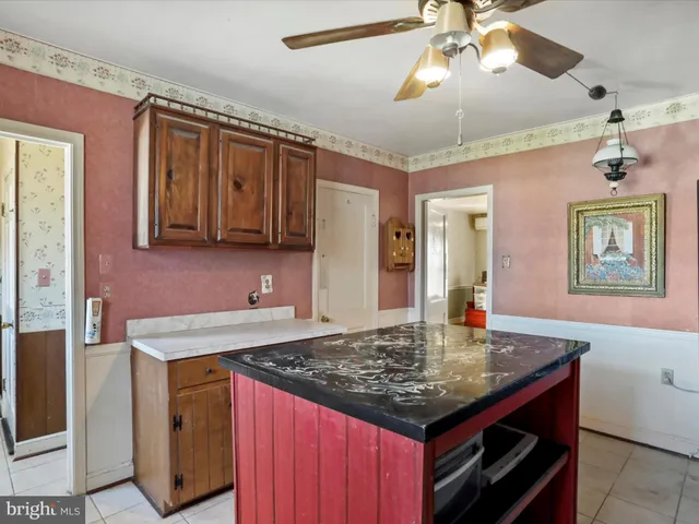 a kitchen with a stove a sink a refrigerator cabinets and wooden floor