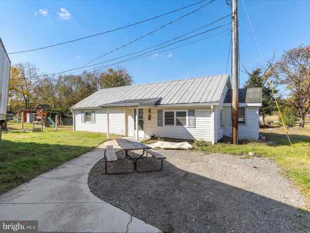 a backyard of a house with barbeque oven