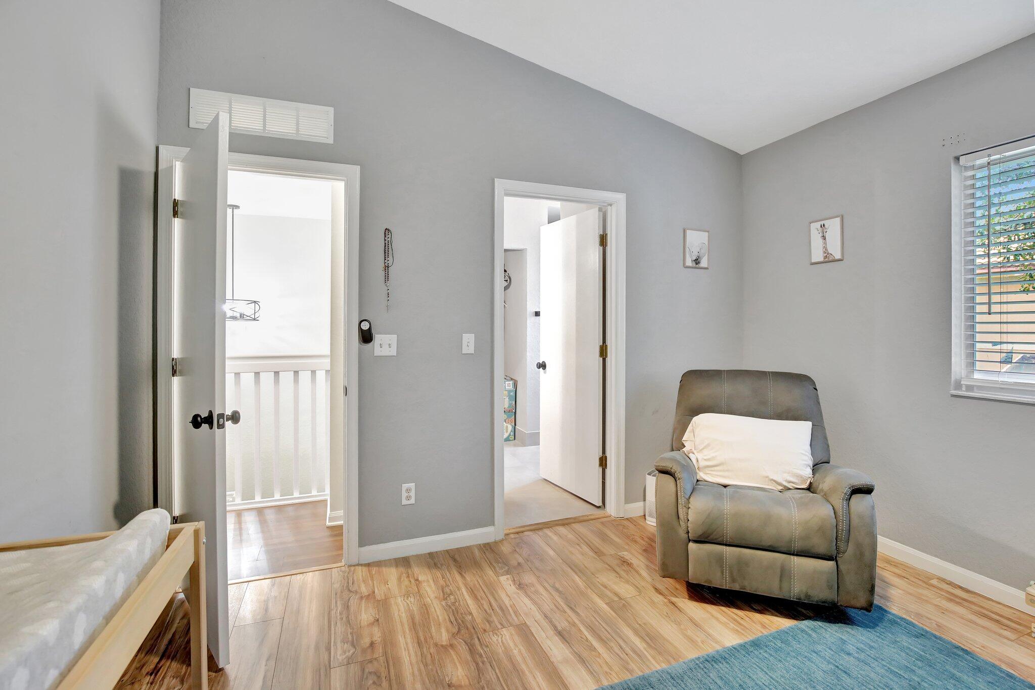 8730 Southwest 21st Street Miramar, FL 33025 - Photo 16 of 45 a bedroom with a bed and wooden floor