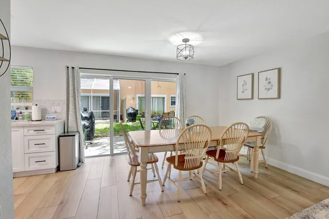 a view of a dining room with furniture wooden floor and chandelier