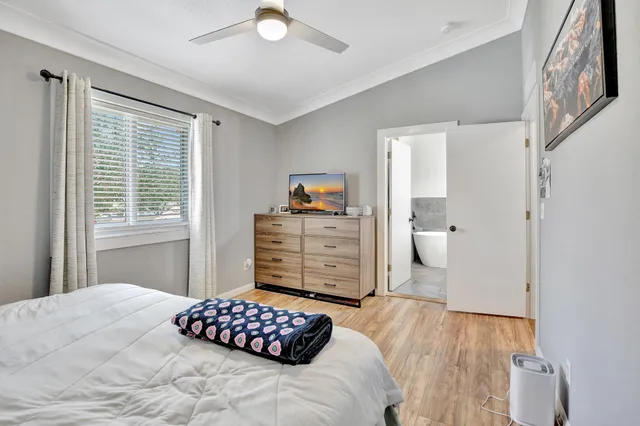 a bedroom with a bed and wooden floor