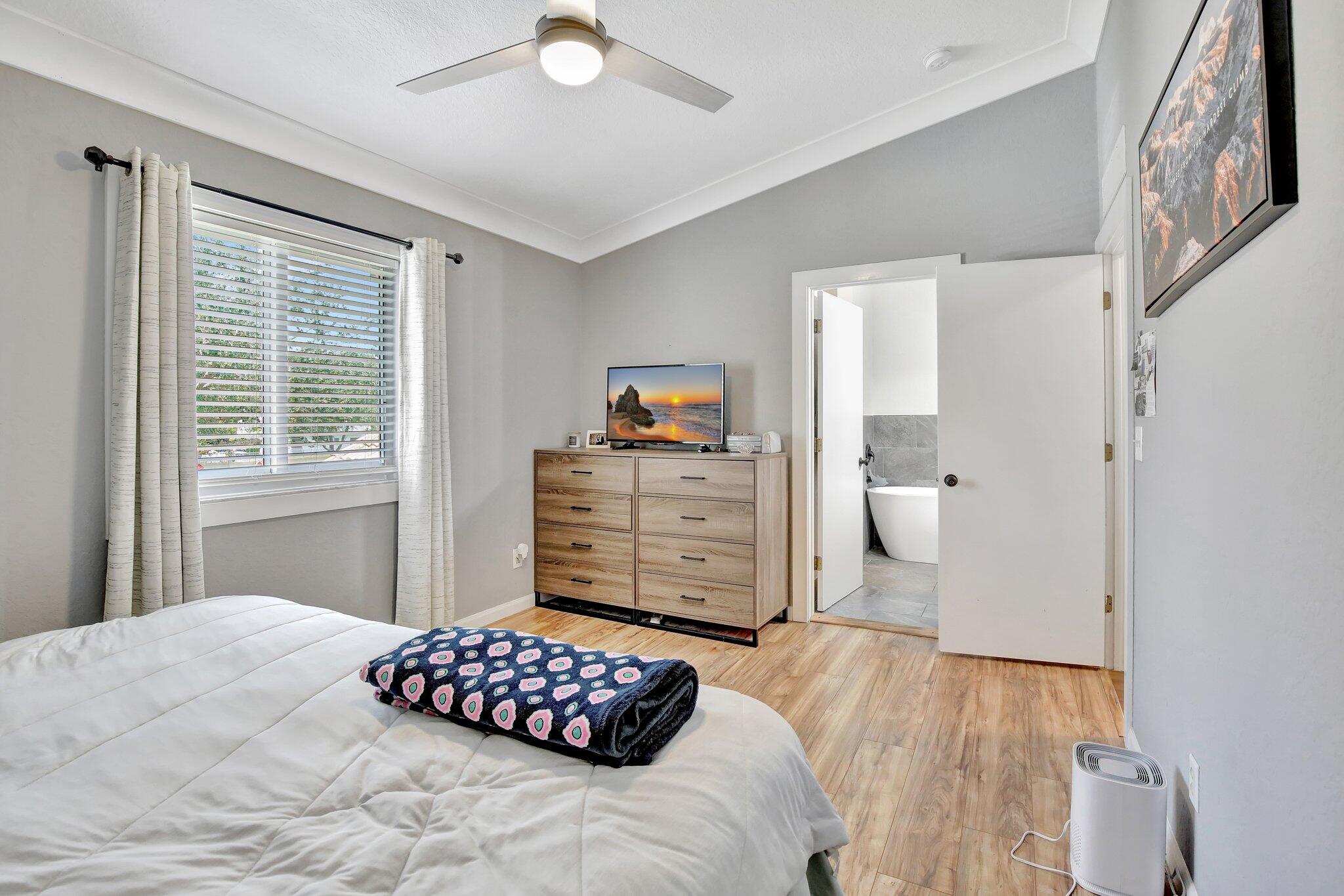 8730 Southwest 21st Street Miramar, FL 33025 - Photo 23 of 45 a bedroom with a bed and wooden floor