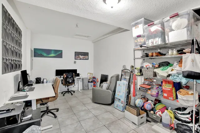 a work room with furniture and a flat screen tv