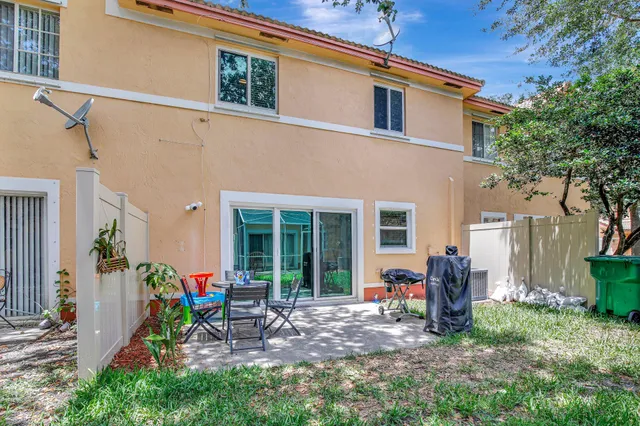 a view of a house with backyard sitting area and garden
