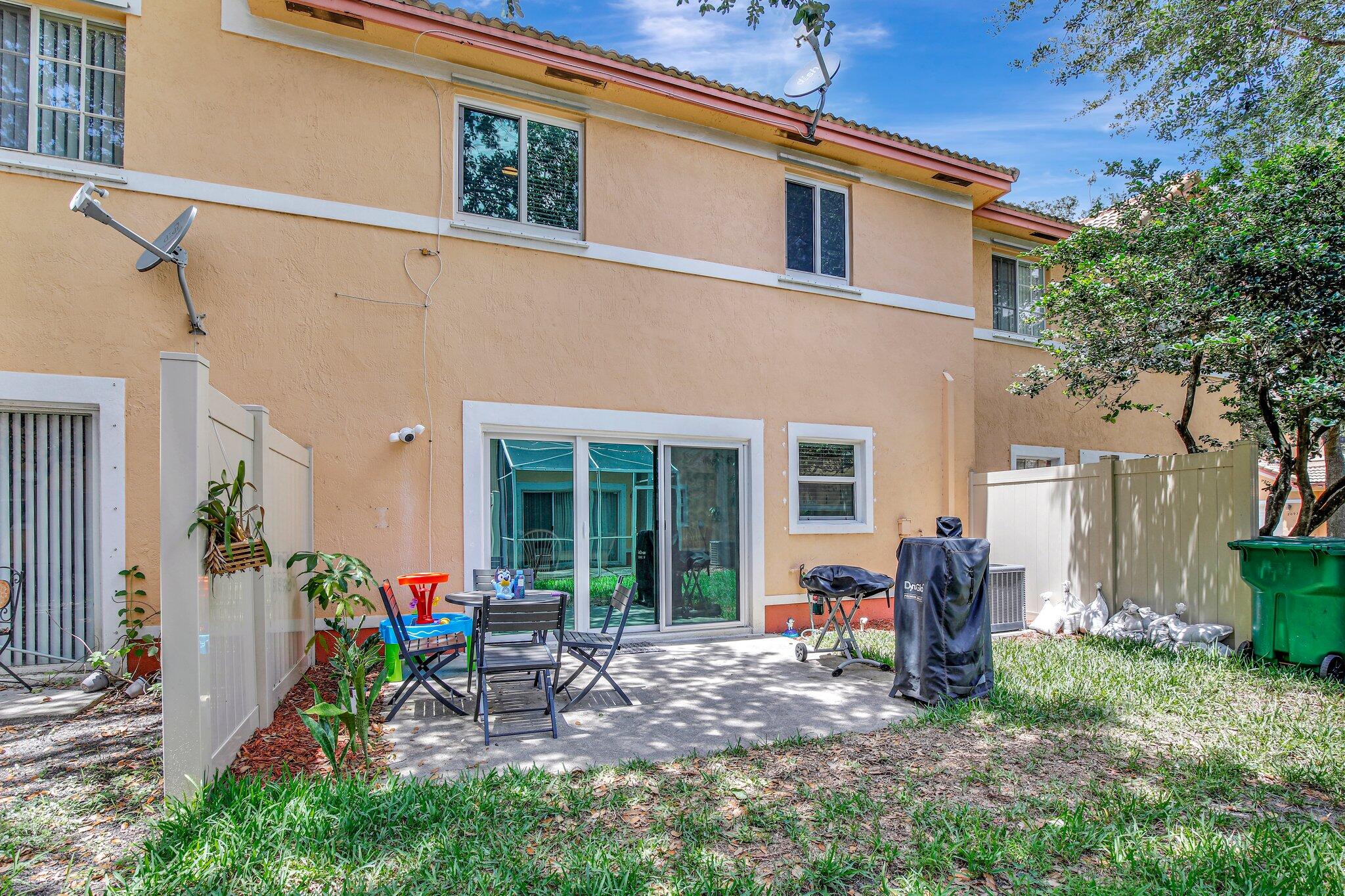 8730 Southwest 21st Street Miramar, FL 33025 - Photo 30 of 45 a view of a house with backyard sitting area and garden