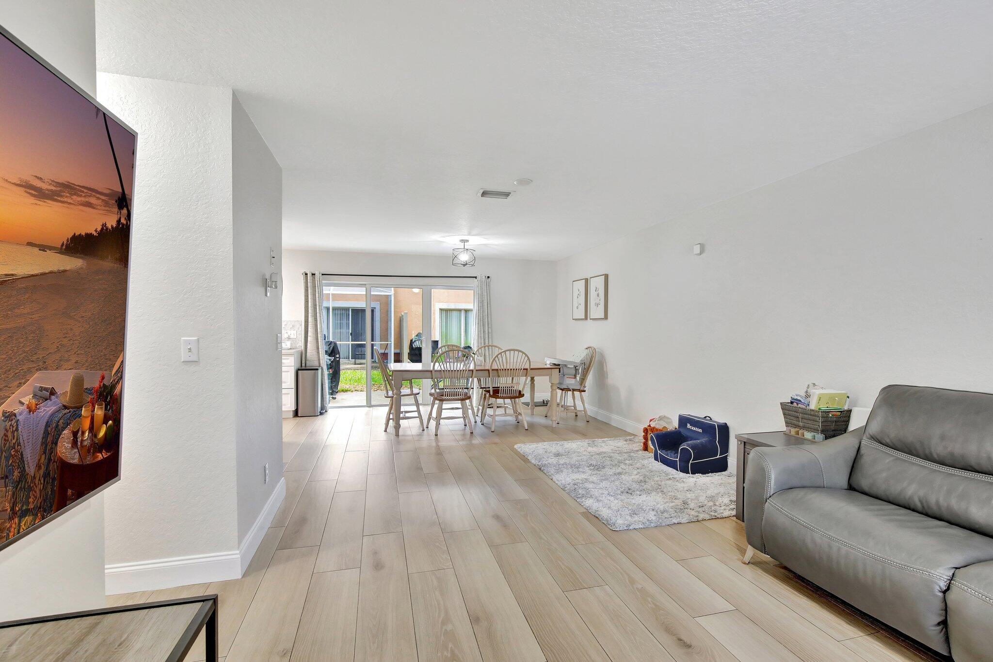 8730 Southwest 21st Street Miramar, FL 33025 - Photo 3 of 45 a living room with furniture and wooden floor
