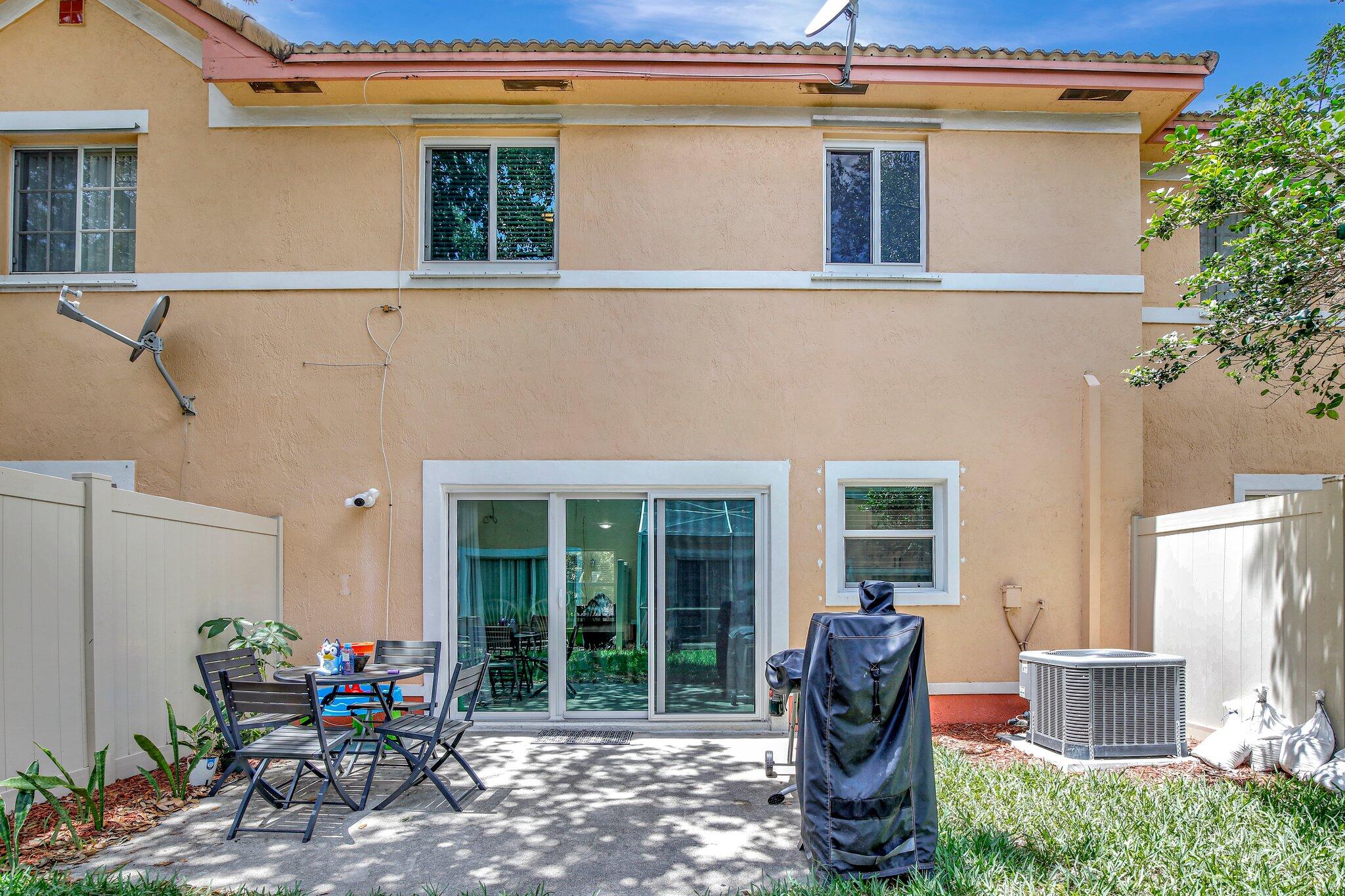 8730 Southwest 21st Street Miramar, FL 33025 - Photo 31 of 45 a view of a house with backyard sitting area and porch