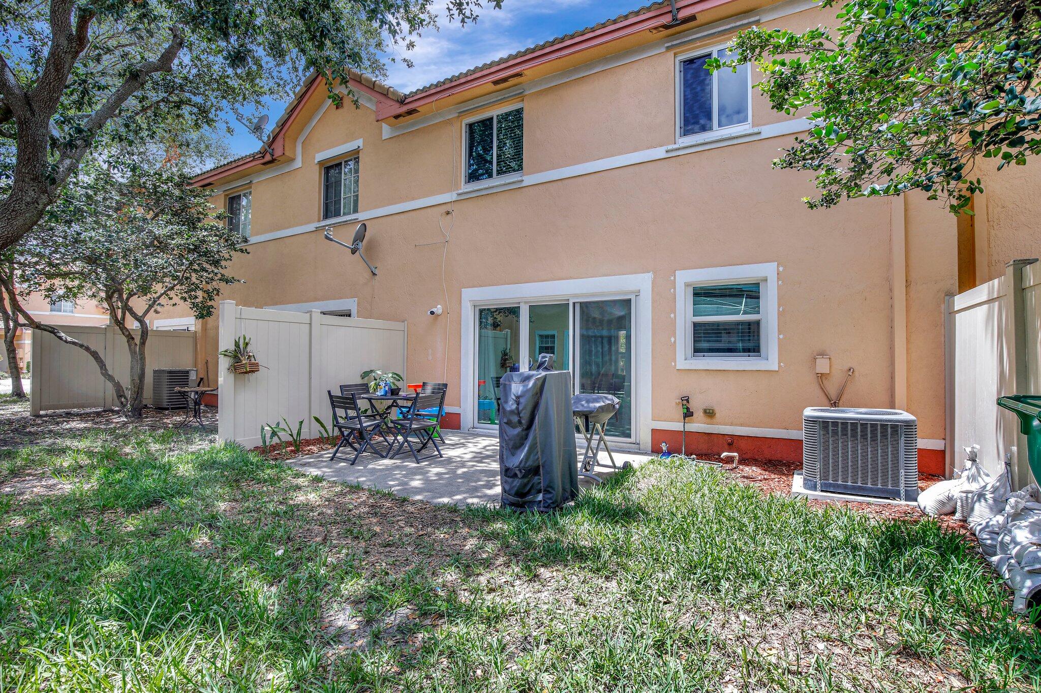 8730 Southwest 21st Street Miramar, FL 33025 - Photo 32 of 45 a front view of a house with patio