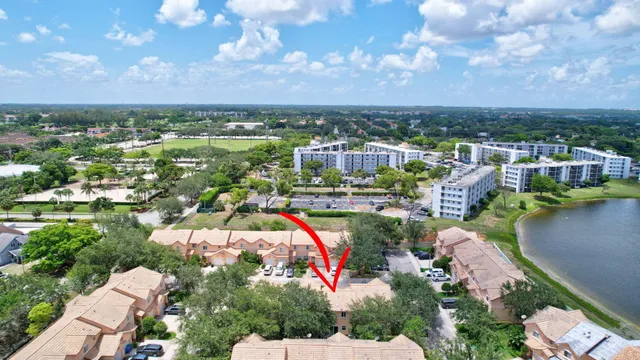 an aerial view of residential houses with outdoor space and lake view