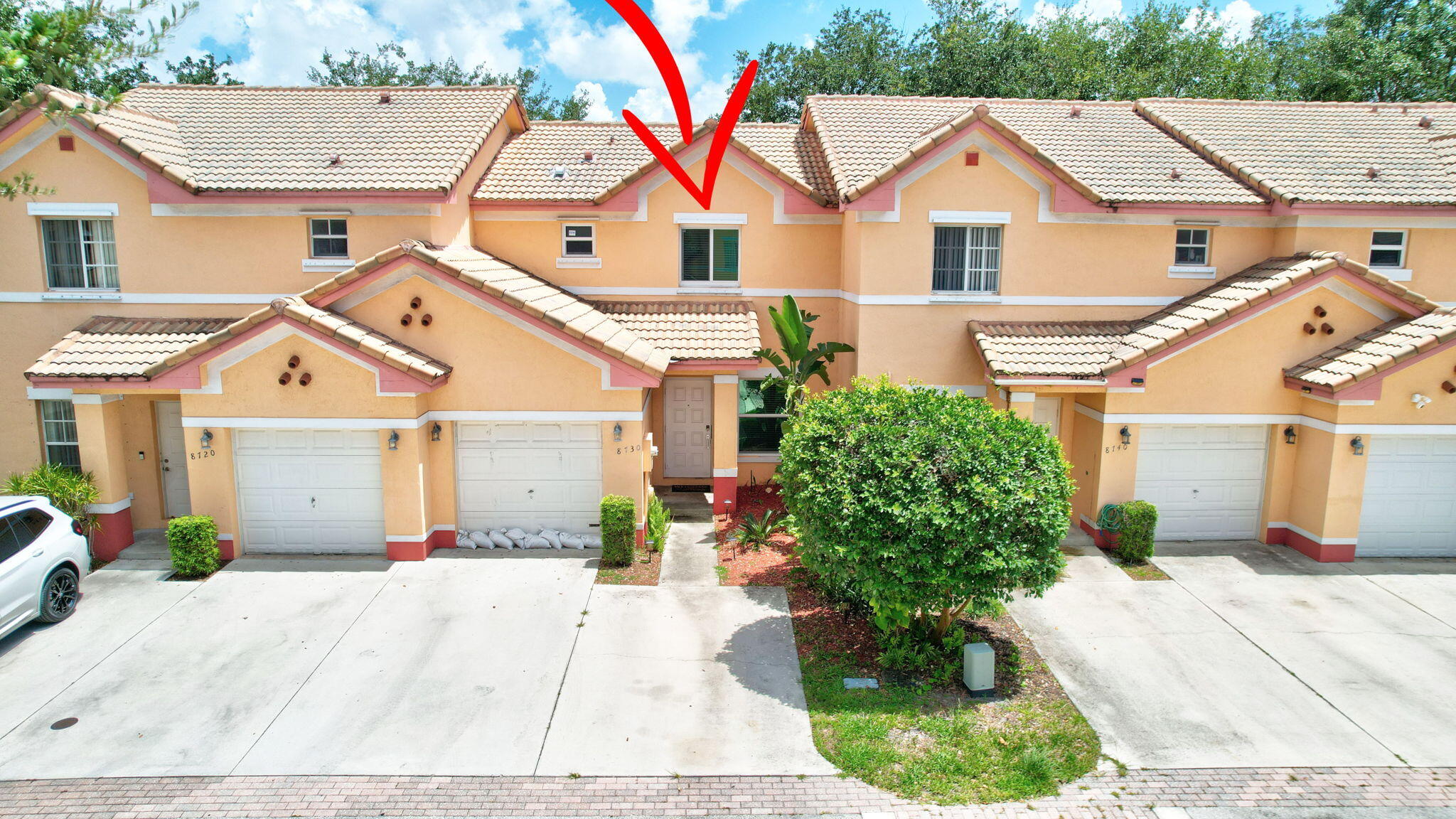 8730 Southwest 21st Street Miramar, FL 33025 - Photo 42 of 45 a view of a white house with a yard and potted plants