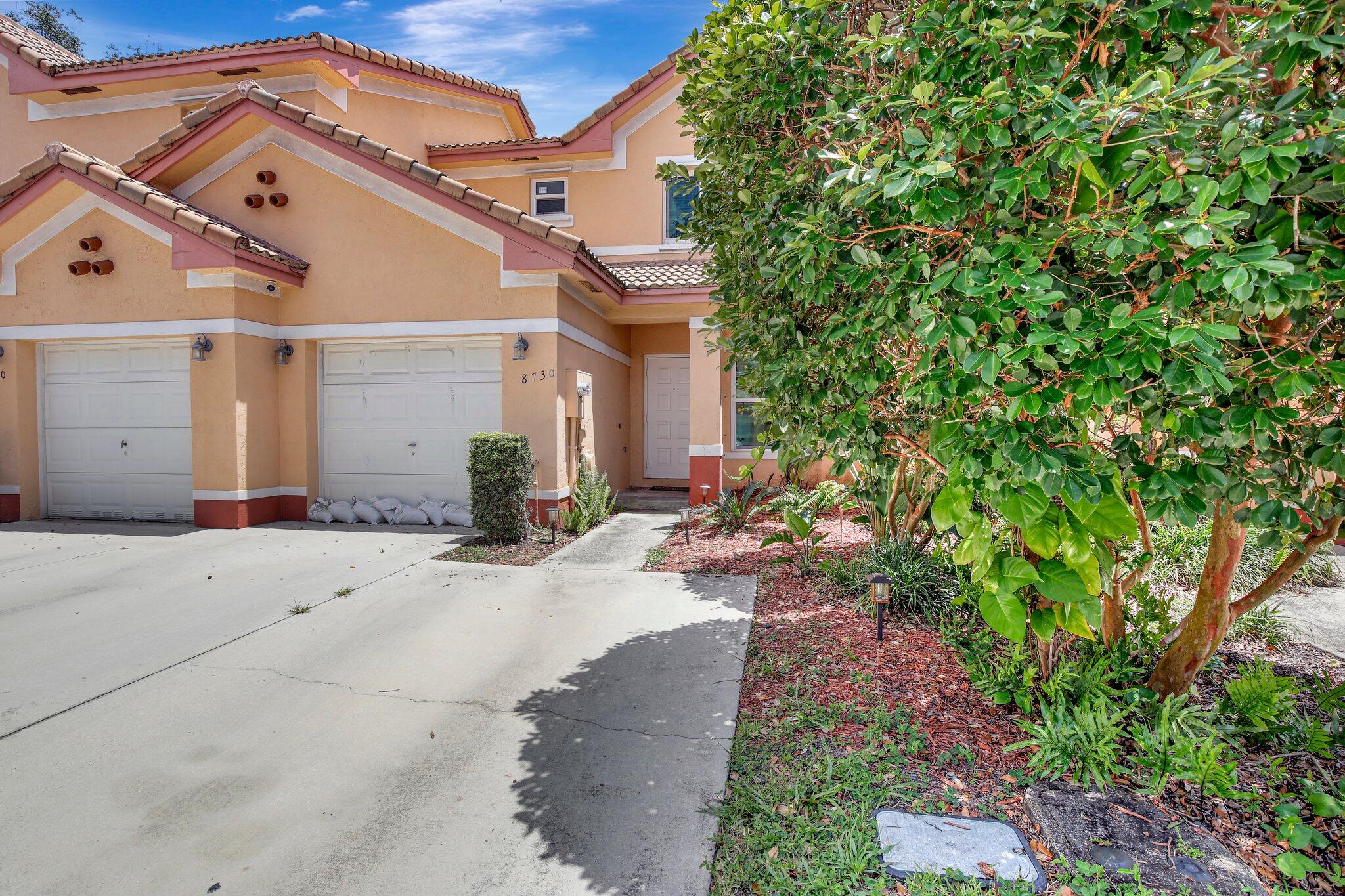 8730 Southwest 21st Street Miramar, FL 33025 - Photo 43 of 45 a view of a house with a small yard and plants