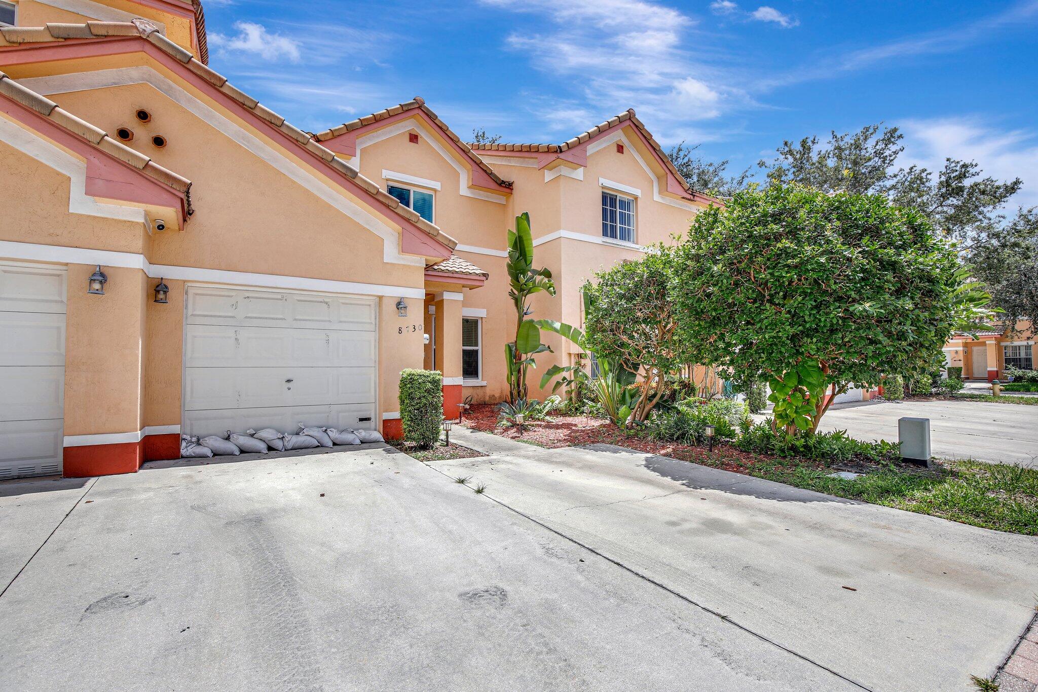 8730 Southwest 21st Street Miramar, FL 33025 - Photo 45 of 45 a front view of a house with a yard and garage