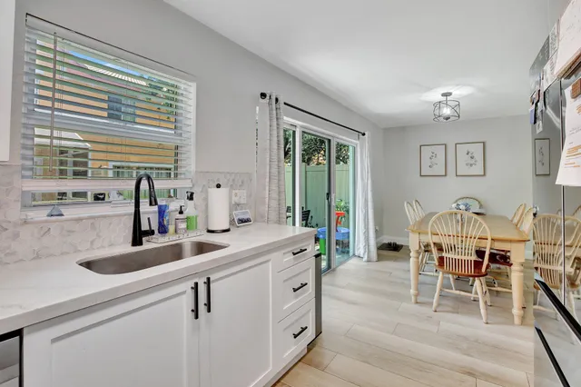 a kitchen with sink cabinets and dining table