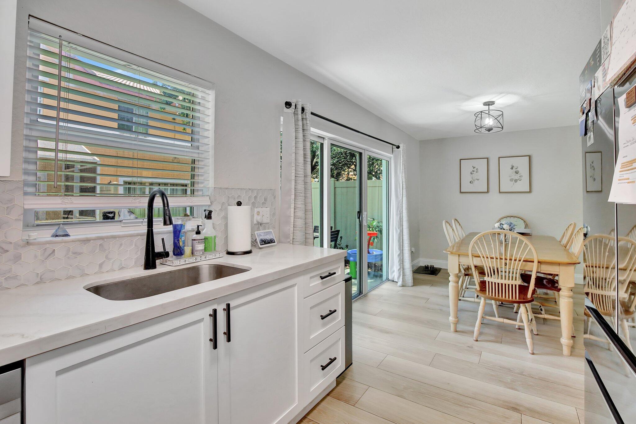 8730 Southwest 21st Street Miramar, FL 33025 - Photo 9 of 45 a kitchen with sink cabinets and dining table