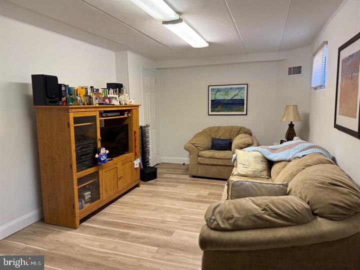 10201-00 Bustleton Avenue, Unit A1 Philadelphia, PA 19116 - Photo 10 of 16 a living room with furniture and a flat screen tv