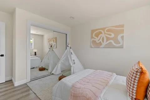 a bed room with a bed and a painting on the wall