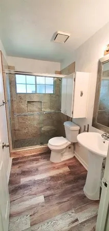 a bathroom with a toilet and a shower