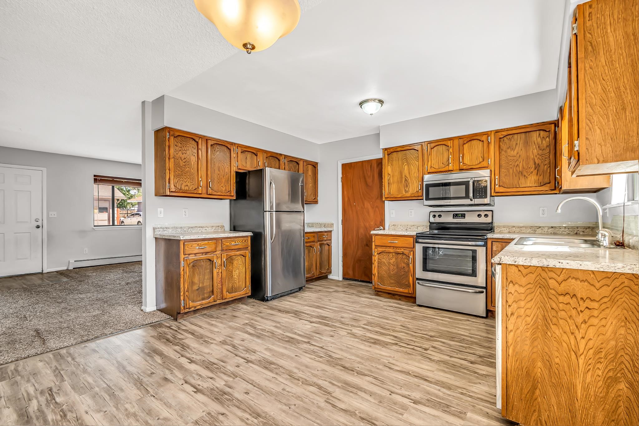 486 Harris Road Grand Junction, CO 81501 - Photo 5 of 15 a kitchen with stainless steel appliances a stove cabinets and a refrigerator