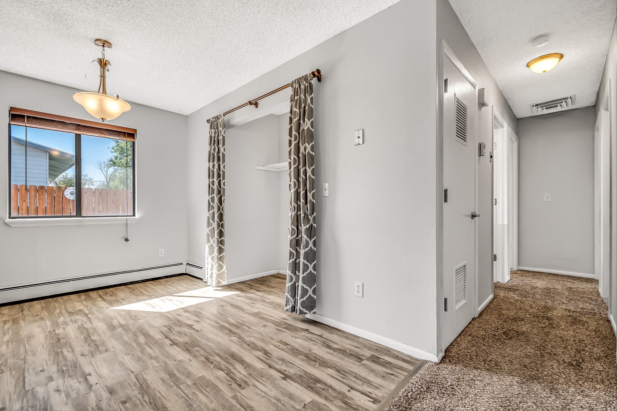486 Harris Road Grand Junction, CO 81501 - Photo 7 of 15 a view of an empty room with window and wooden floor