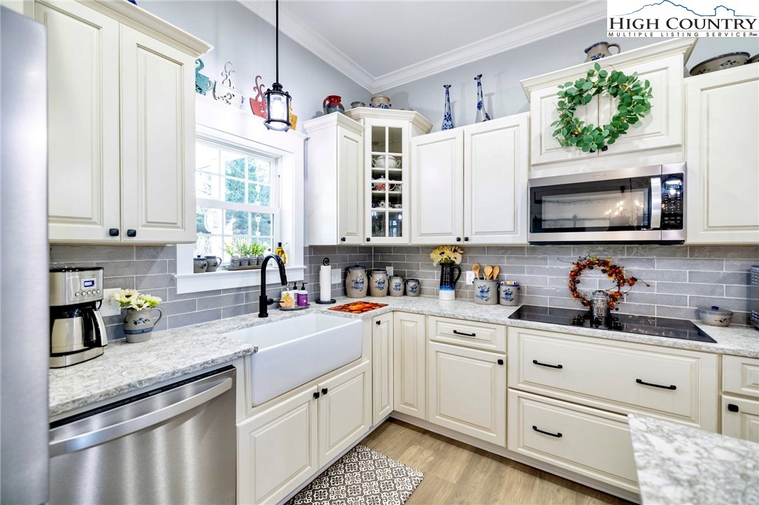 461 Chestnut Ridge Drive Jefferson, NC 28640 - Photo 13 of 47 a kitchen with granite countertop a sink stainless steel appliances and cabinets