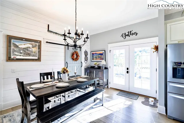 a kitchen with stainless steel appliances granite countertop a refrigerator a stove and a sink with wooden floor