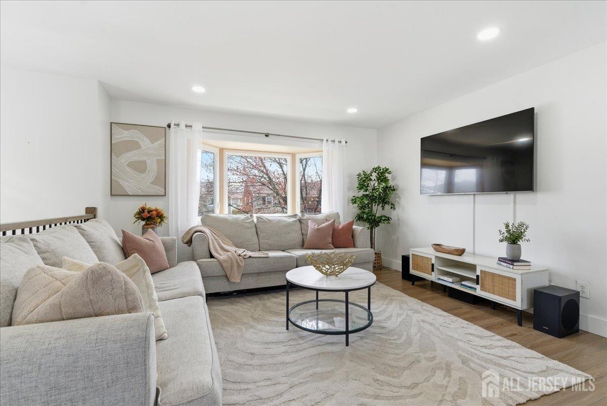 83 Garfield Avenue Colonia, NJ 07067 - Photo 11 of 45 a living room with furniture and a flat screen tv