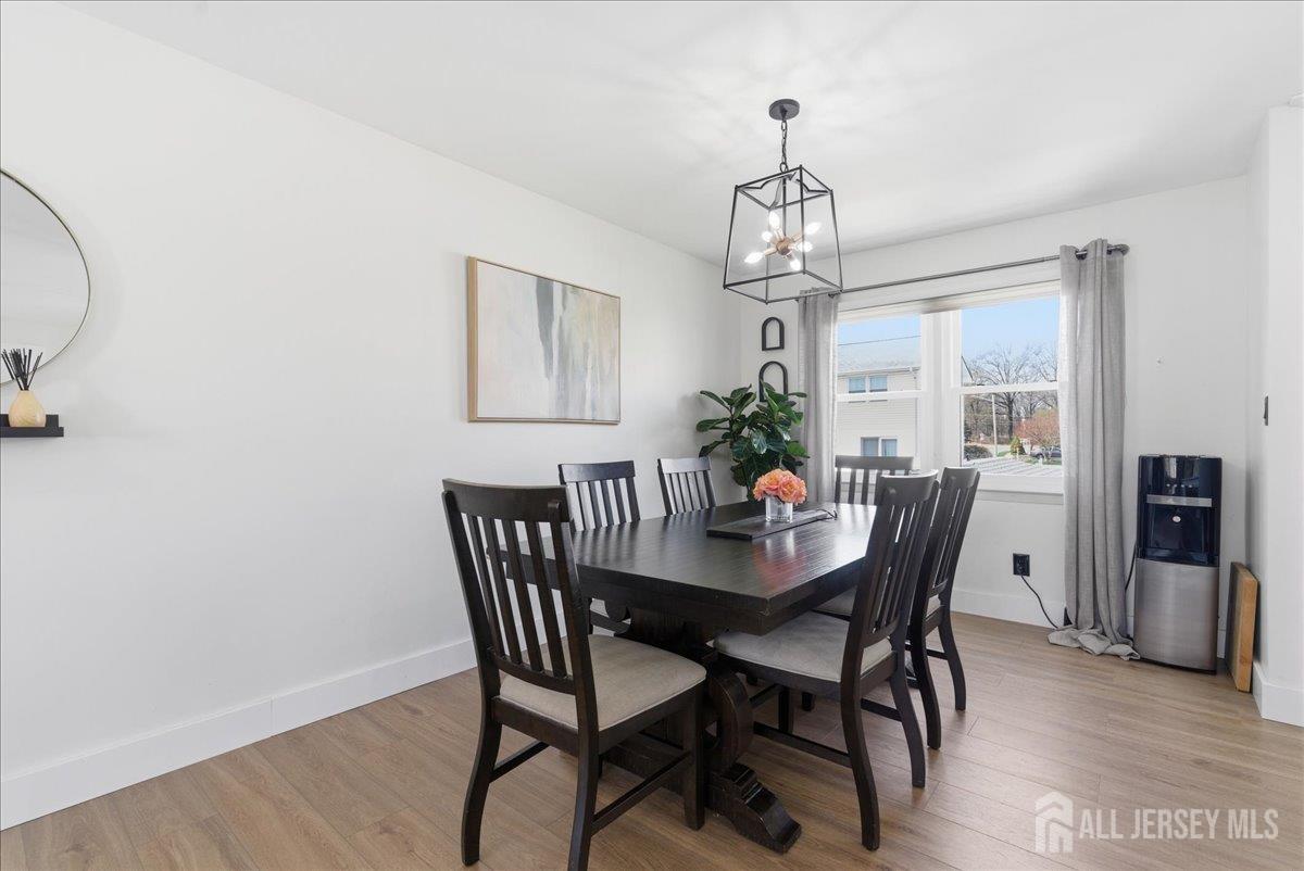83 Garfield Avenue Colonia, NJ 07067 - Photo 14 of 45 a view of a dining room with furniture window and wooden floor