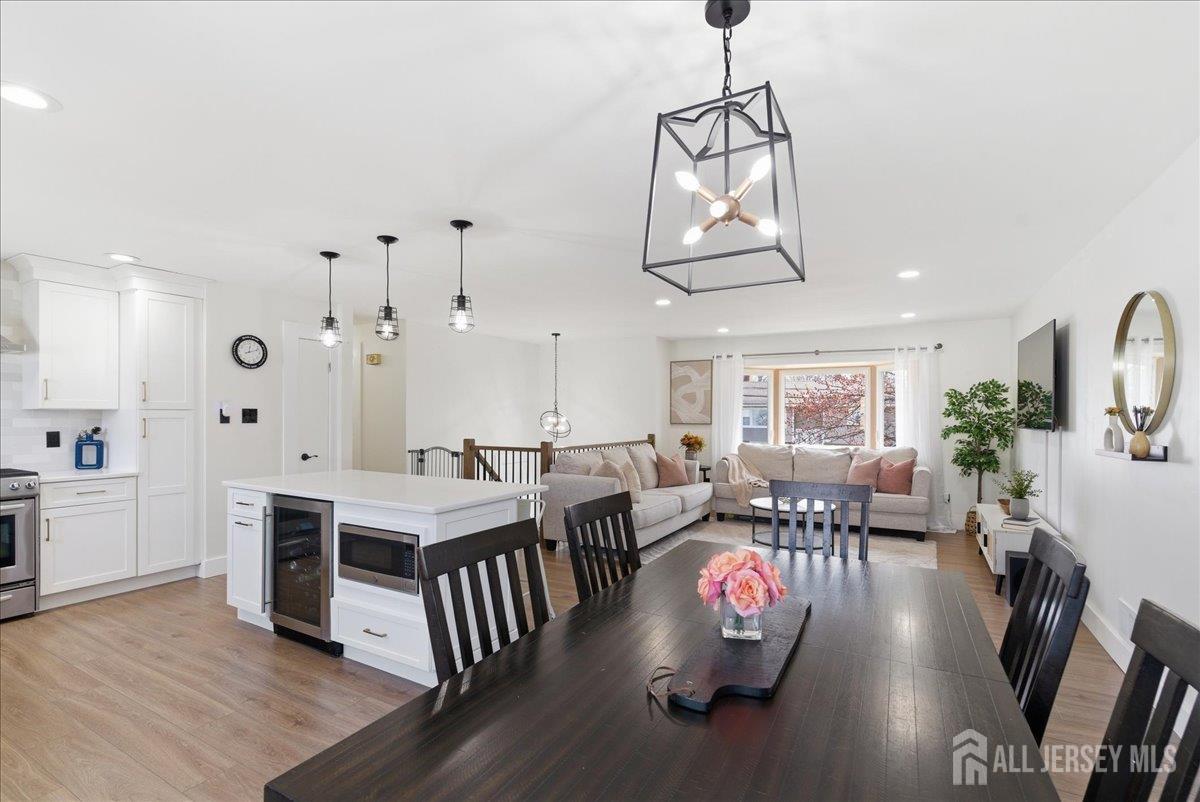 83 Garfield Avenue Colonia, NJ 07067 - Photo 15 of 45 a living room with stainless steel appliances granite countertop furniture dining table and wooden floor