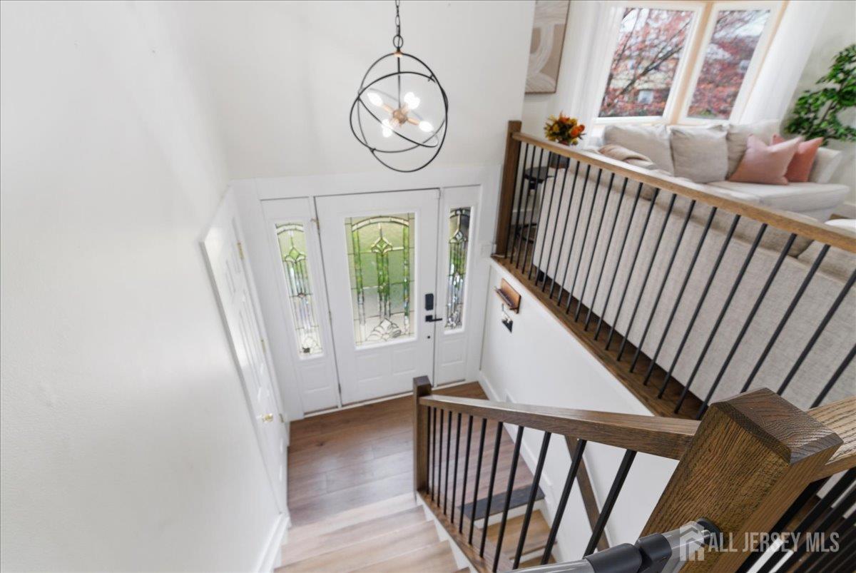 83 Garfield Avenue Colonia, NJ 07067 - Photo 2 of 45 a view of a hallway with wooden floor and windows