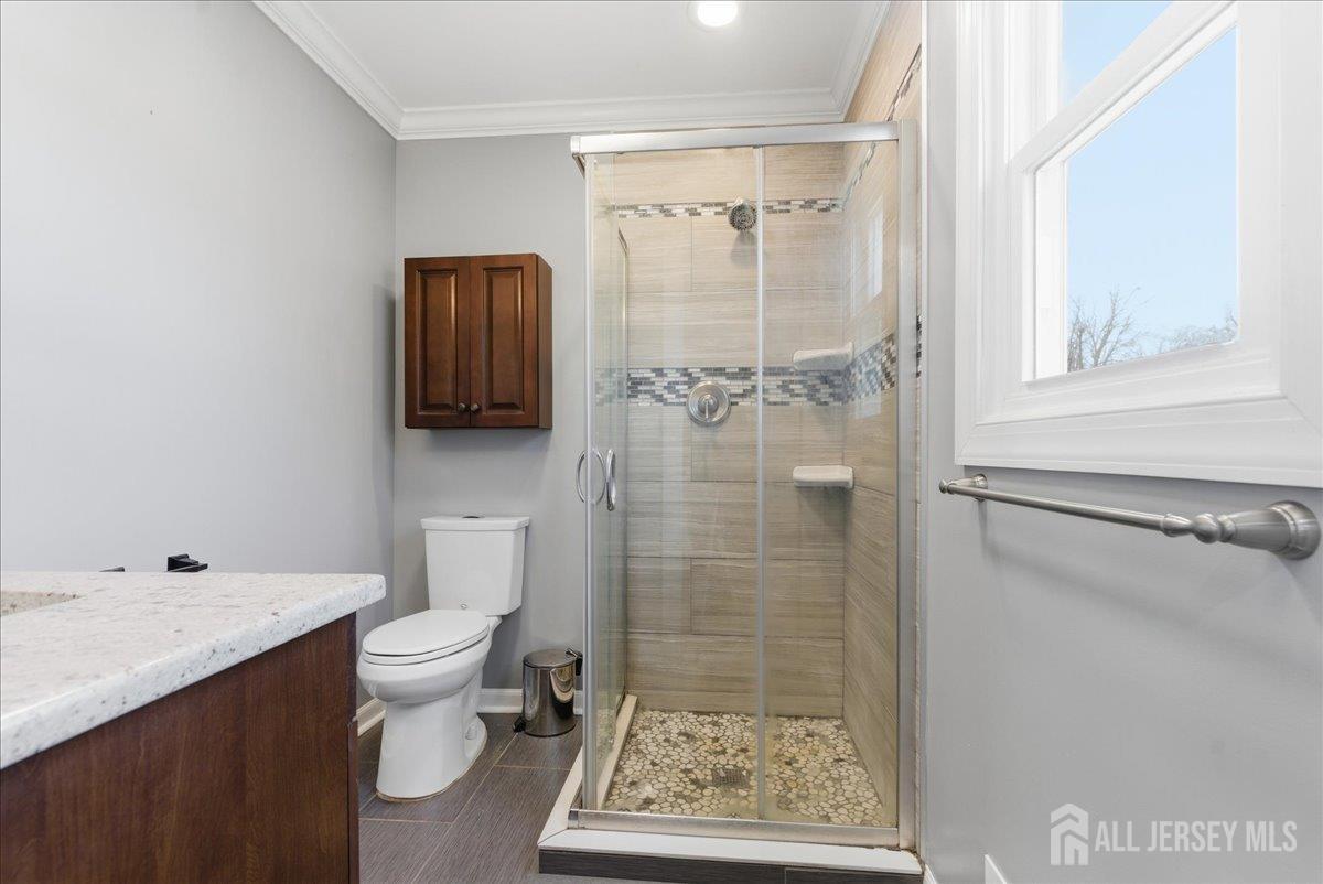 83 Garfield Avenue Colonia, NJ 07067 - Photo 24 of 45 a bathroom with a toilet sink and shower