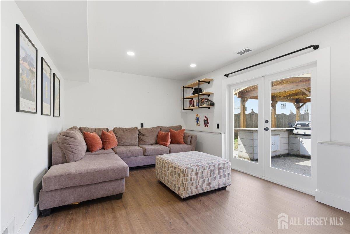 83 Garfield Avenue Colonia, NJ 07067 - Photo 27 of 45 a living room with furniture and a wooden floor